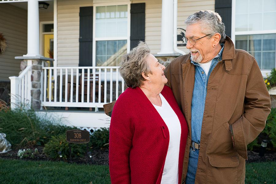 Temple Health COPD patient John happily standing with wife outside their home