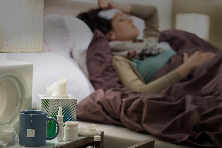 Woman sick in bed with the flu