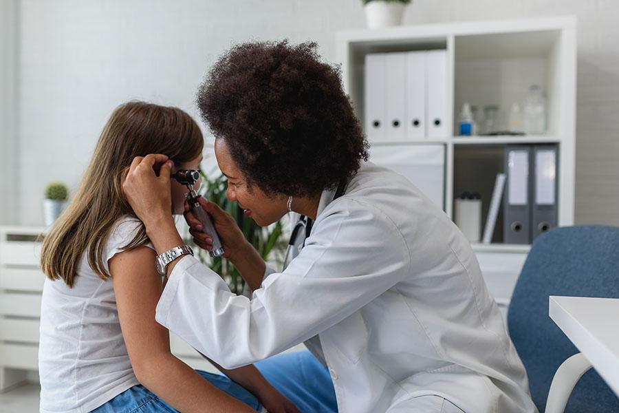 Doctor Checking Patient`s Temperature in the Ear with Tympanic