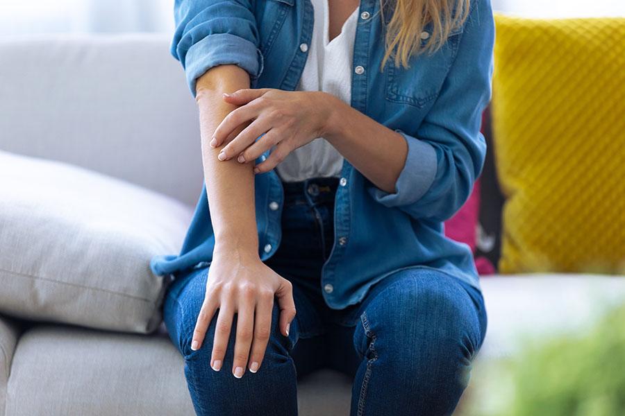 Woman itching her arm