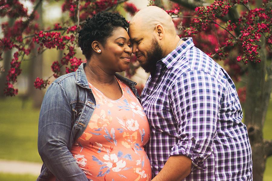 Pregnant woman and man embracing one another