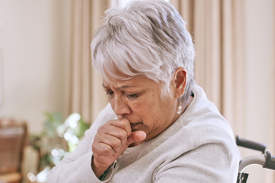 Chronic Bronchitis Patient   Older Woman Coughing Into Hand 