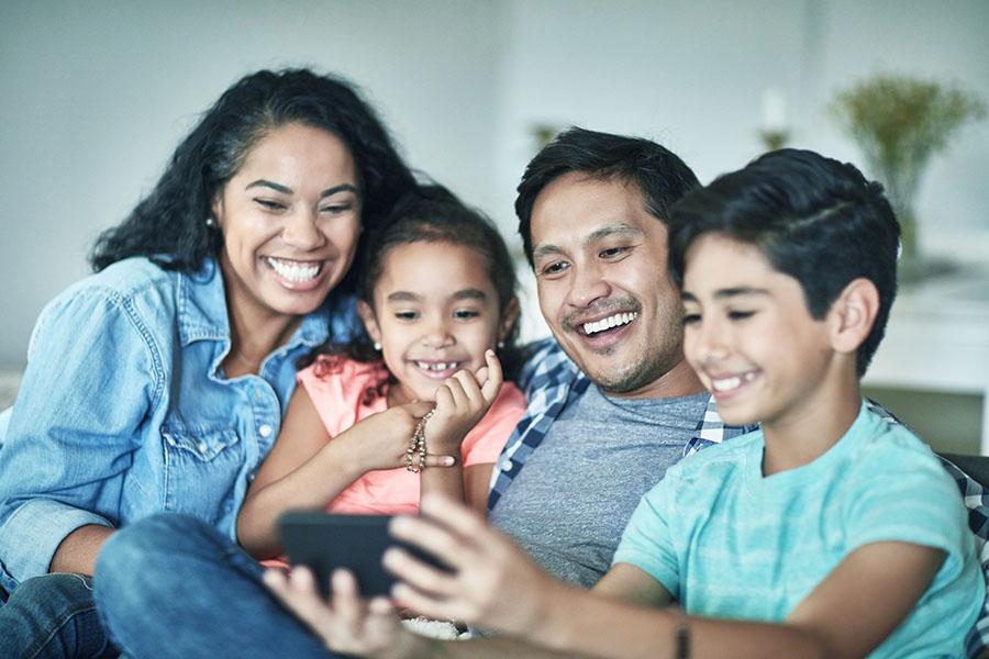 Hispanic family videochatting with relatives